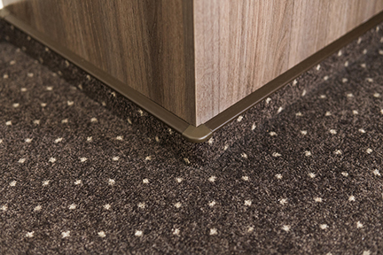 Brown Carpet Floor With A White Dots With A Carpet Baseboard On